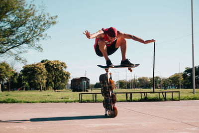 Skateboarder jumping boards