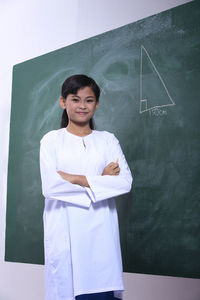 Portrait of girl against blackboard in school