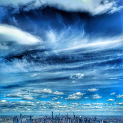 Scenic view of sea by buildings against sky