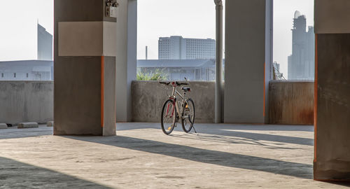 Bicycle on street against buildings in city