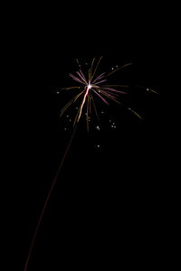 Low angle view of firework display at night