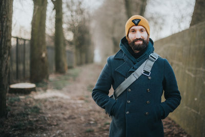 Portrait of young man standing on road