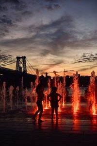 Silhouette people against sky during sunset