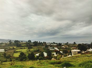 Houses on field against sky