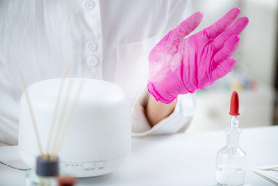 Perfumer or scientist smelling fragrance from humidifier, testing it.