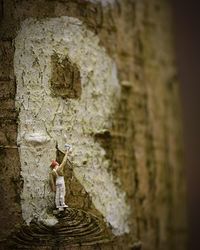 Old statue against building wall