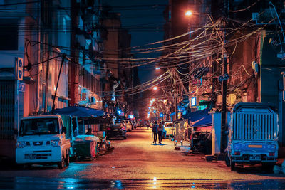 Illuminated city street at night