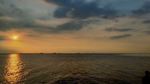 Scenic view of sea against sky at sunset