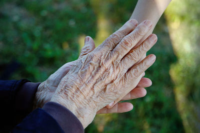 High angle view of hand holding hands