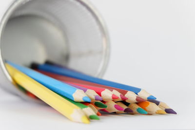 Close-up of multi colored pencils on white background