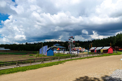 View of rural landscape against cloudy sky