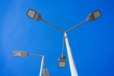 Street lamps on a pole against the sky