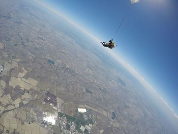 Couple skydiving in italy, looking at the horizon from  above 