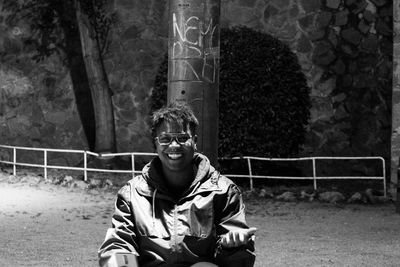 Portrait of young man sitting outdoors