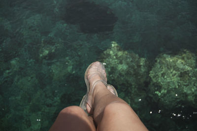 Low section of woman in sea