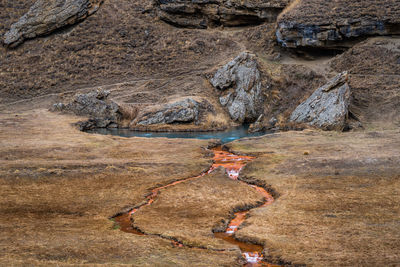 Side view of rock formations and river with lake