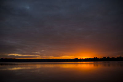 Scenic view of lake against orange sky