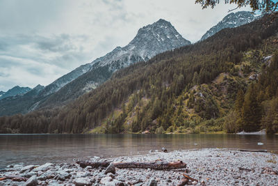 Scenic view of lake by mountains against sky