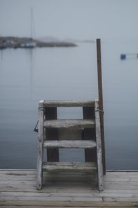 Wooden pier on lake against sky