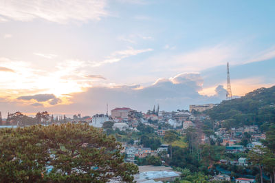 High angle view of buildings against cloudy sky