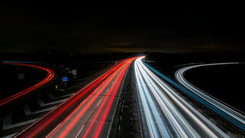 High angle view of light trails on highway at night