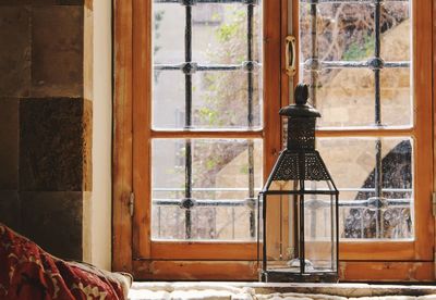 Oil lamp on window sill at home