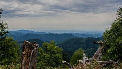 Scenic view of mountains against cloudy sky