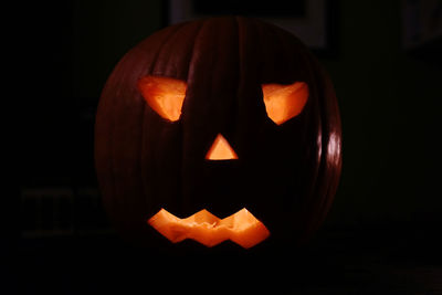 Close-up of illuminated halloween pumpkin against black background