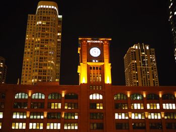 Low angle view of clock tower at night