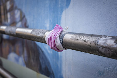 High angle view of pink pipe on railing