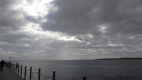 Scenic view of sea against storm clouds