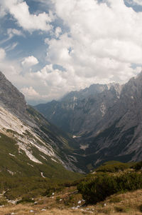 Scenic view of mountains against cloudy sky