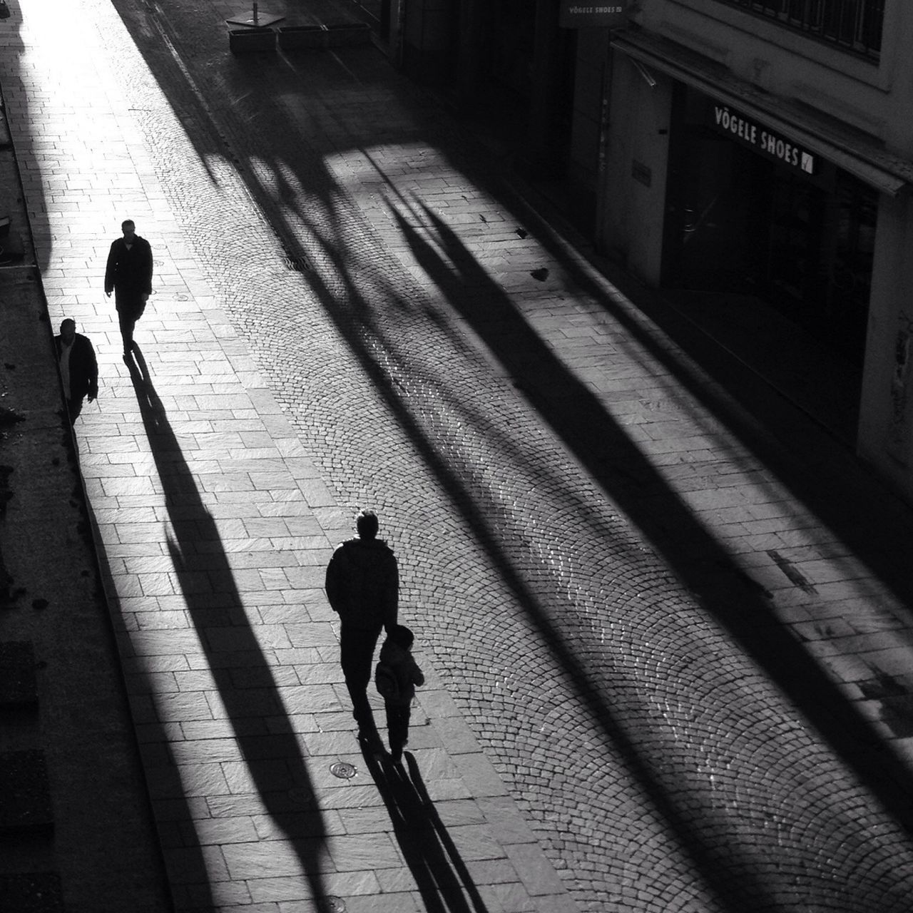 walking, full length, rear view, built structure, street, architecture, lifestyles, building exterior, men, street light, silhouette, shadow, the way forward, leisure activity, person, standing, sidewalk