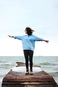 Rear view of woman standing on beach