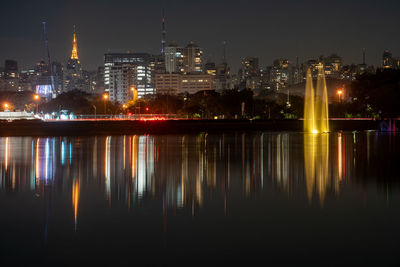 Illuminated buildings against sky at night