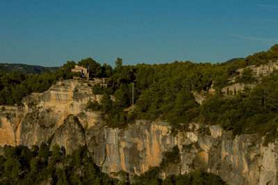 Panoramic view of trees on mountain against blue sky