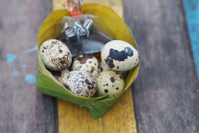 Close up quail eggs boiled eat with soya sauce in banana leaf bowl