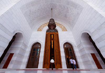 Rear view of people walking in building