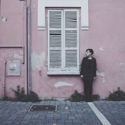 Full length of woman standing by railing