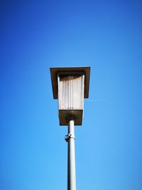 Low angle view of street light against clear blue sky