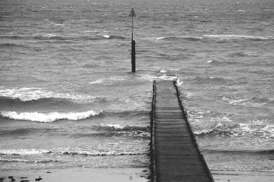 High angle view of wooden posts on beach