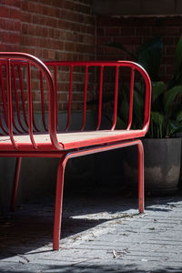 Empty chairs against wall in city