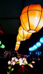 Low angle view of illuminated lanterns hanging on ceiling