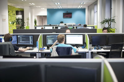 Staff working on computers in office cubicles