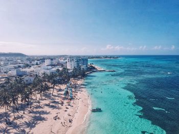 Aerial view of seascape against blue sky during sunny day