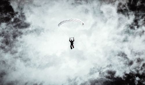 Low angle view of person paragliding