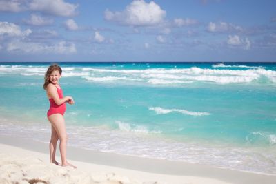 Girl standing at beach during summer