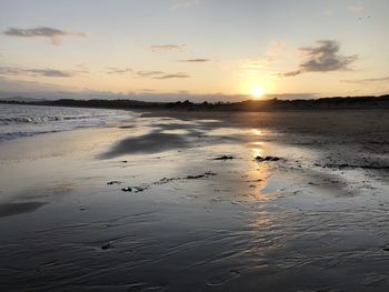 Scenic view of beach against sky during sunset