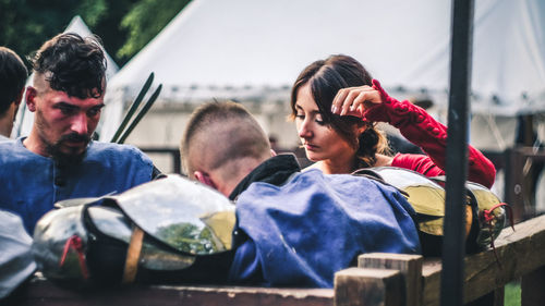 Portrait of young people sitting outdoors