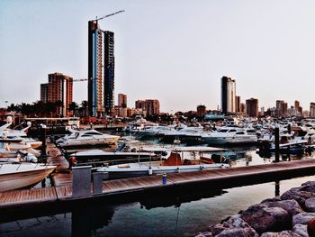 View of marina and buildings against clear sky